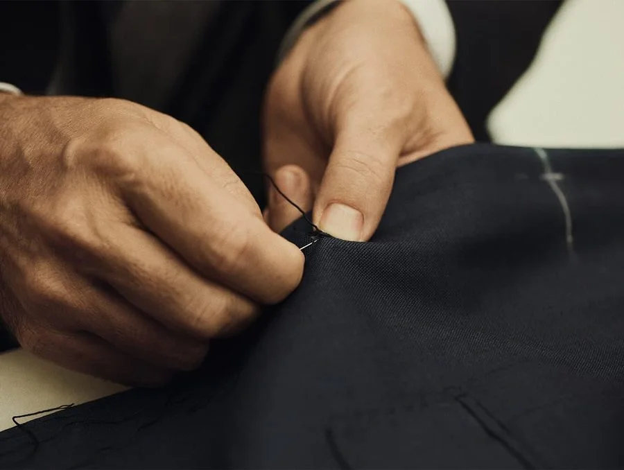 Hand stitching detail work on dark technical fabric
