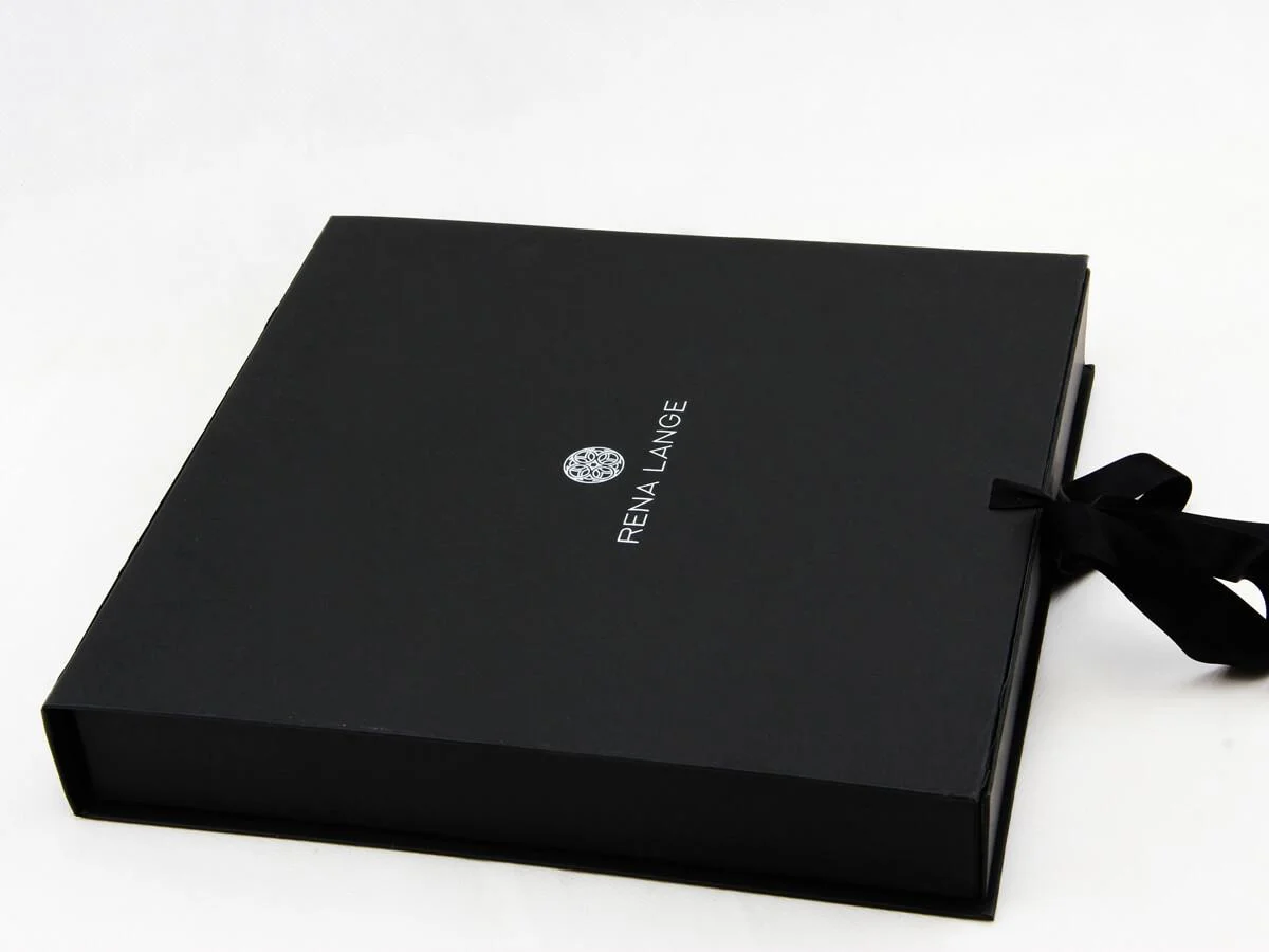 Custom rigid apparel box with ribbon and branded finish