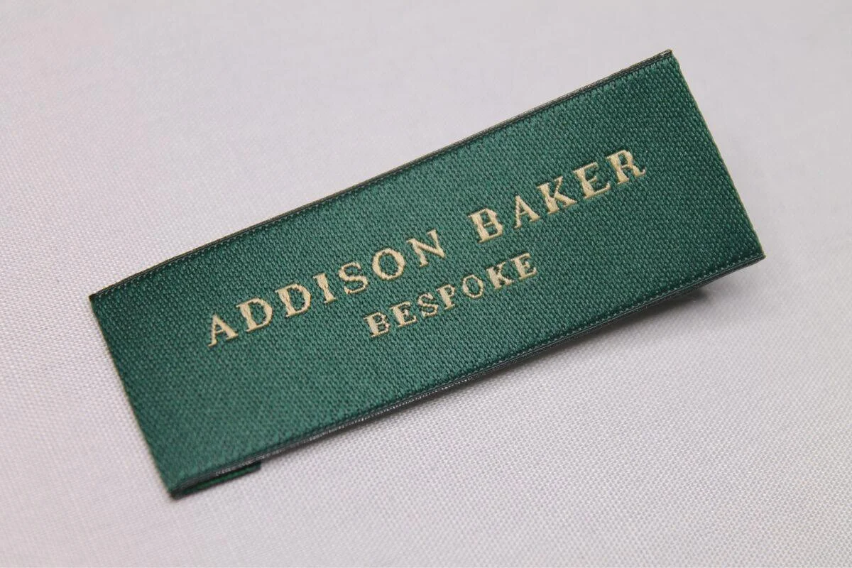 Woven damask brand label sewn into apparel